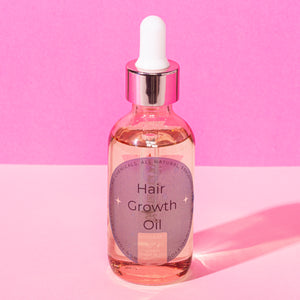 A bottle of hair growth oil by Happy Whole You.