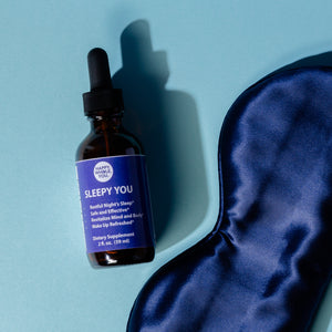 A bottle of Sleepy You Tincture with eye mask for a good night sleep.